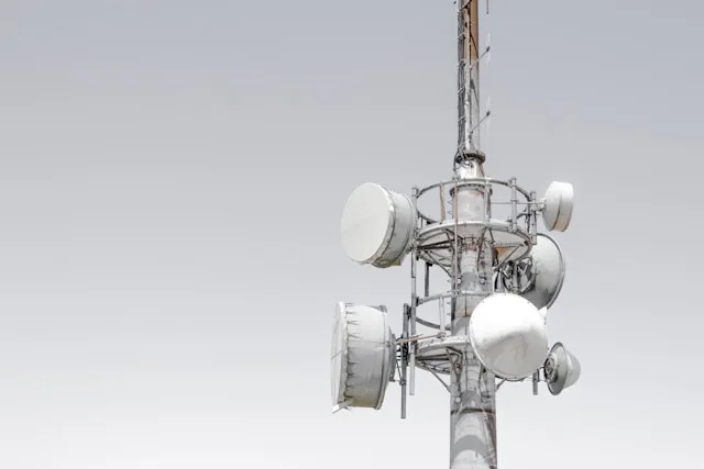 Metal tower carrying wireless antennas and dishes