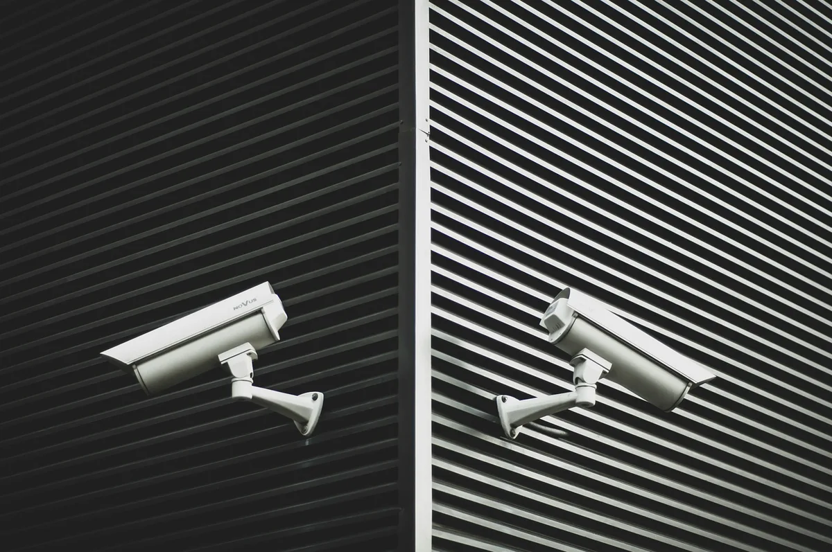 Two security cameras mounted on an exterior wall
