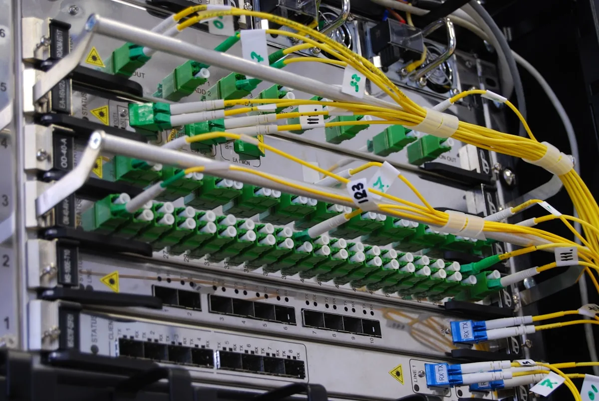 Network switch rack with yellow fiber patch cables